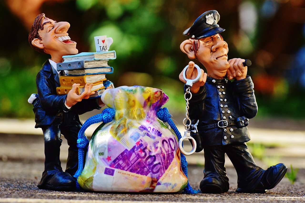 Image - taxes tax evasion police handcuffs