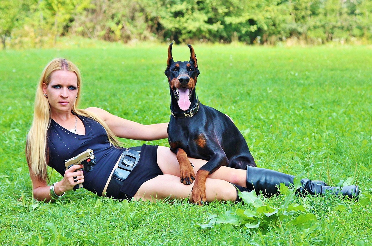 Image - weapon doberman dog woman pistol