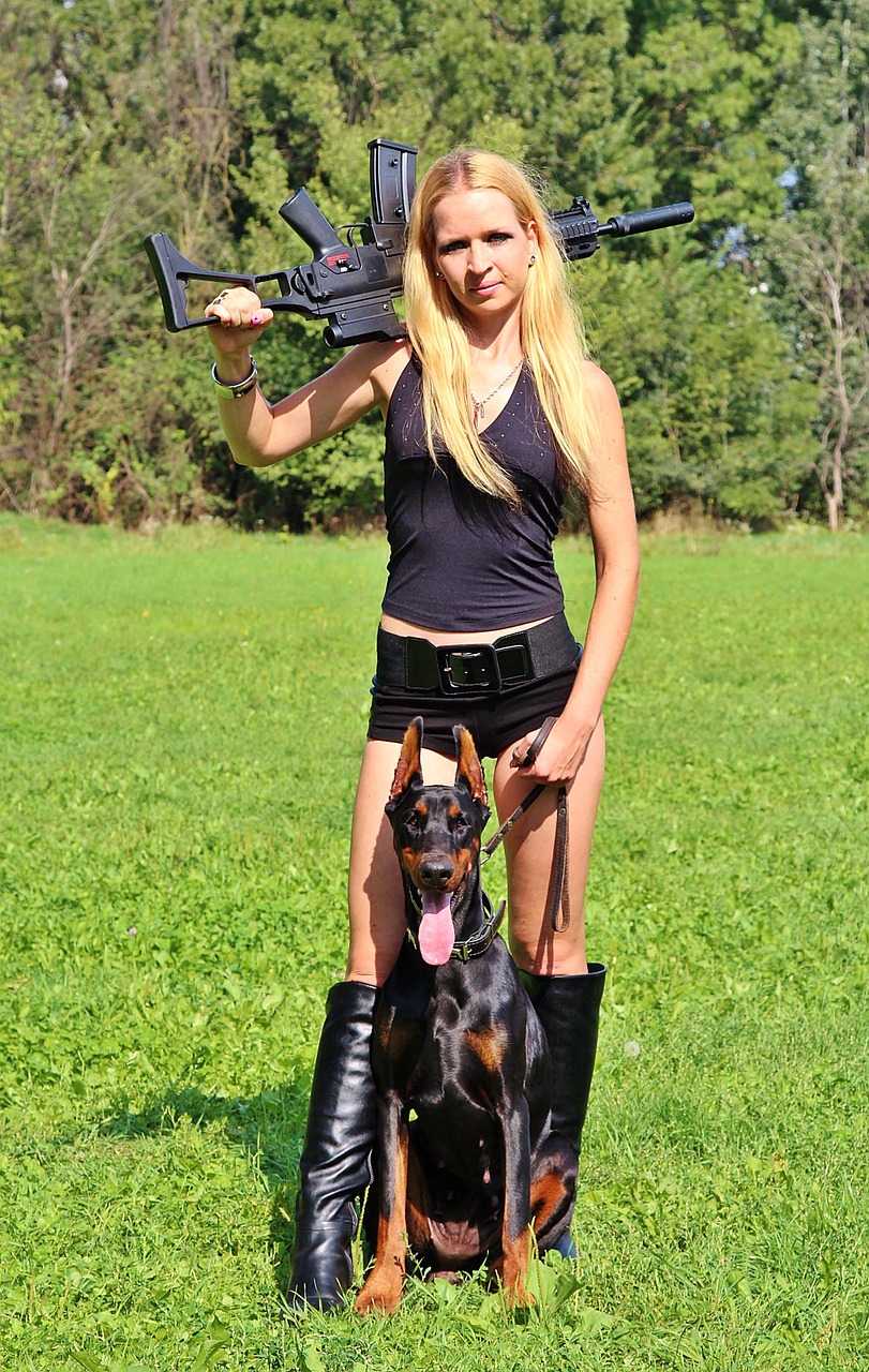 Image - weapon doberman dog woman pistol