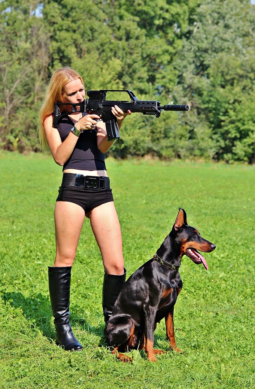 Image - weapon doberman dog woman pistol