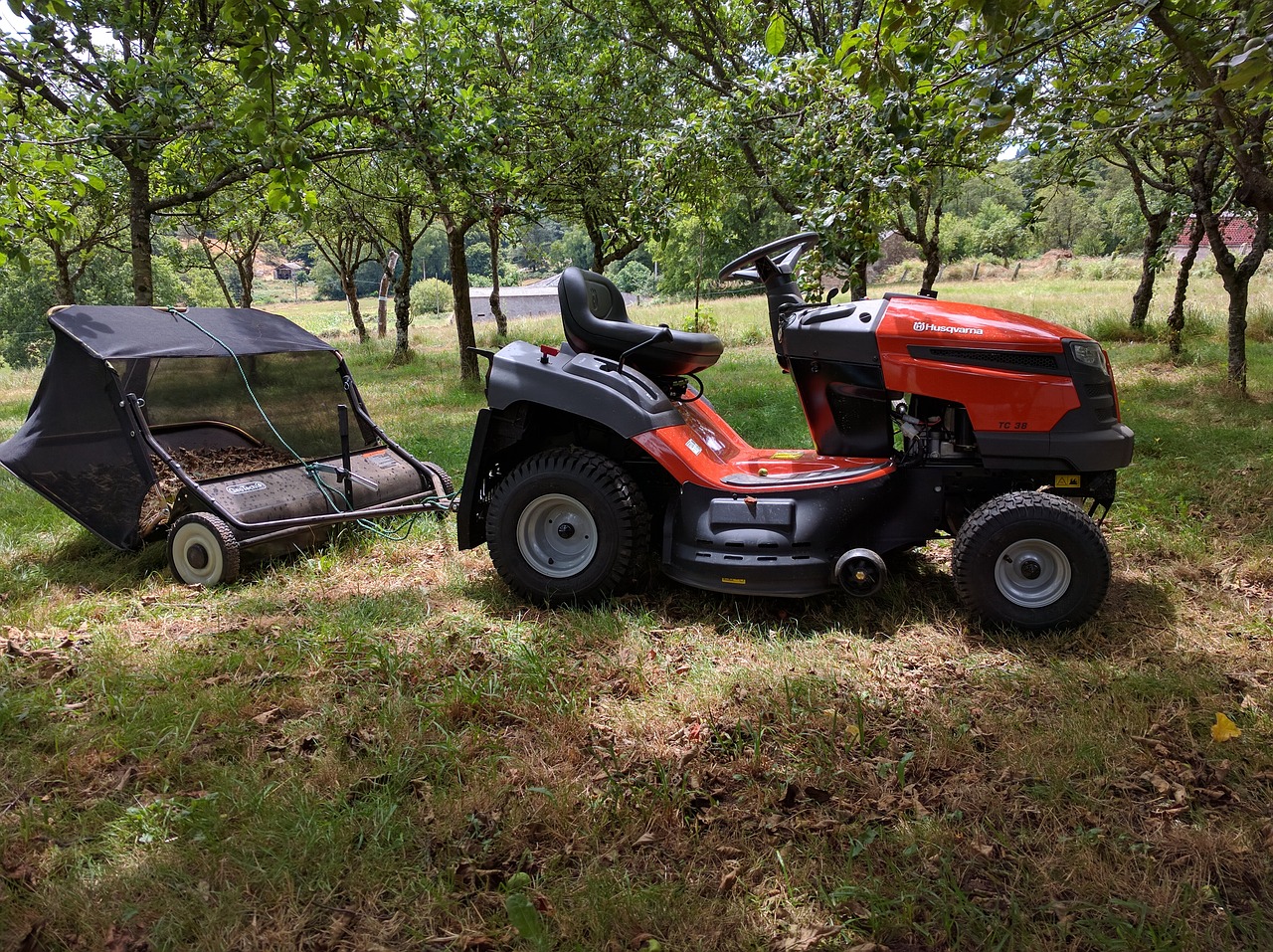 Image - tractor sweeper leaves apple trees