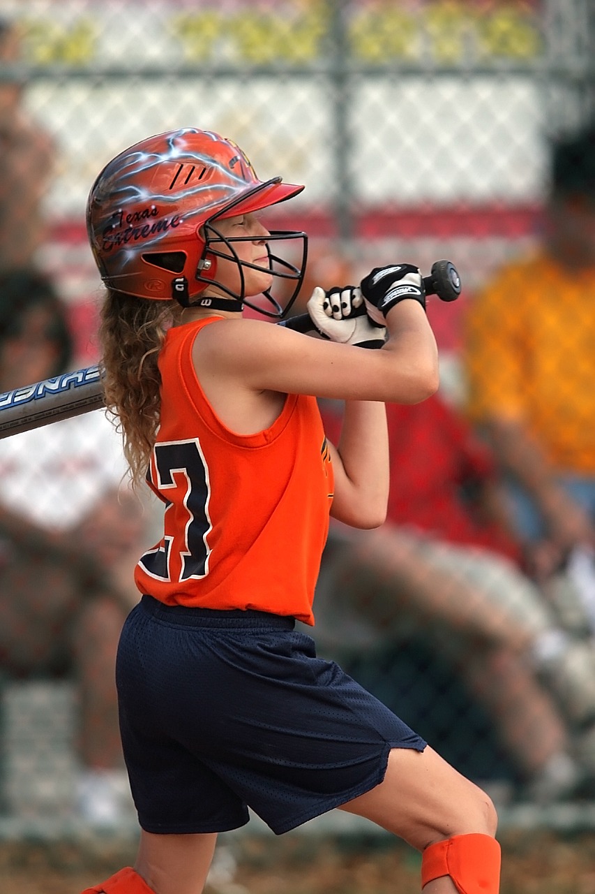 Image - softball player swinging batter