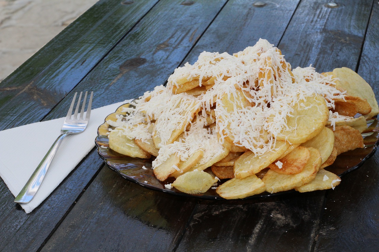 Image - fried potatoes cheese fork plate