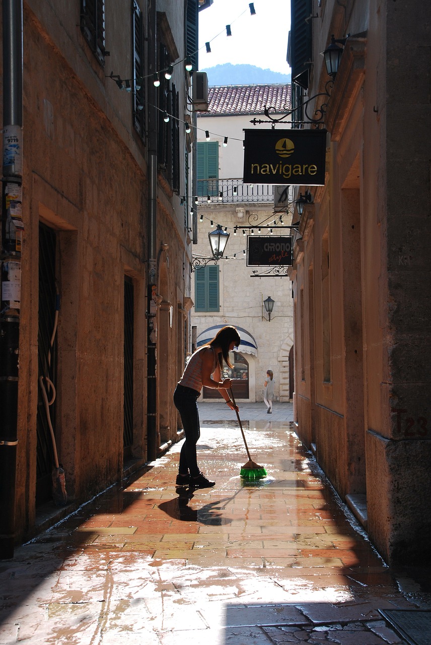 Image - woman cleaning sweeping street