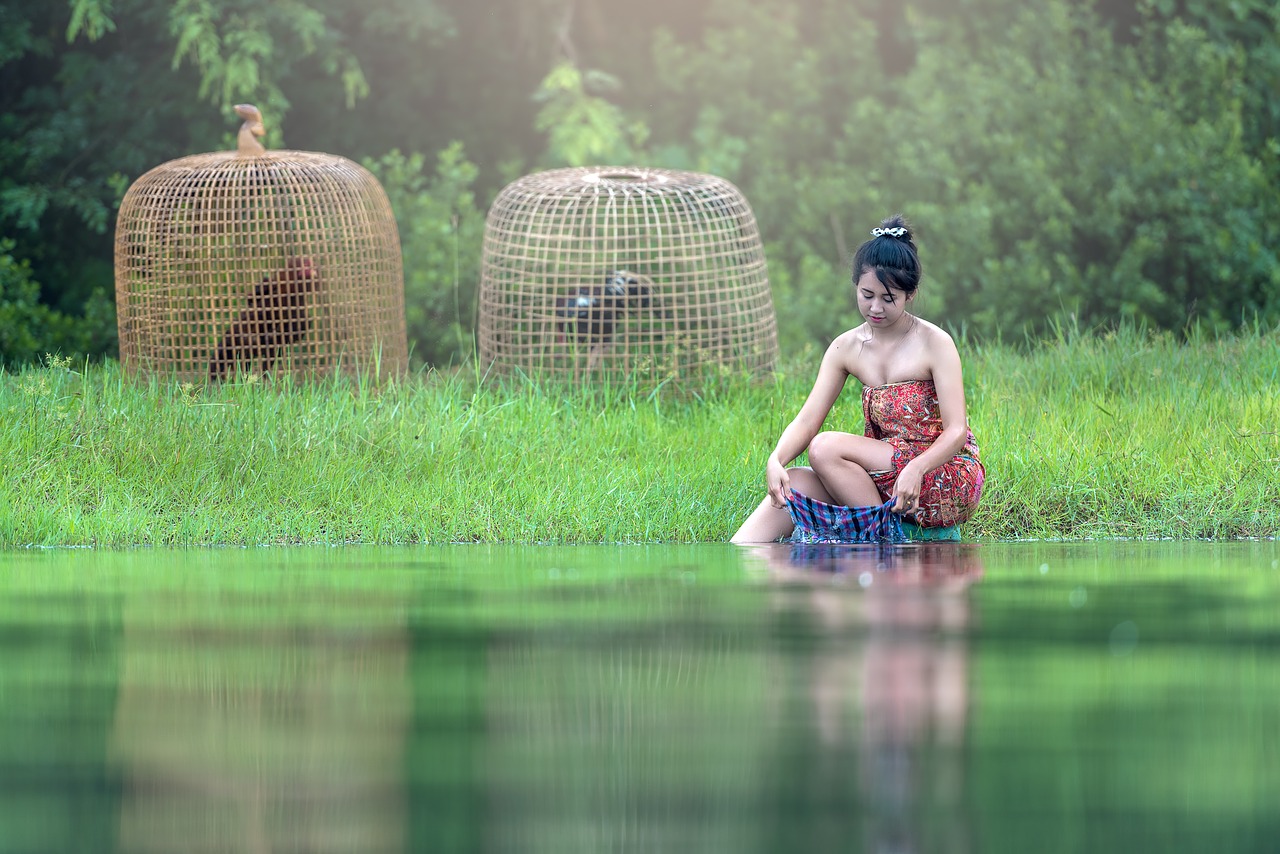 Image - cleaning clothing river woman