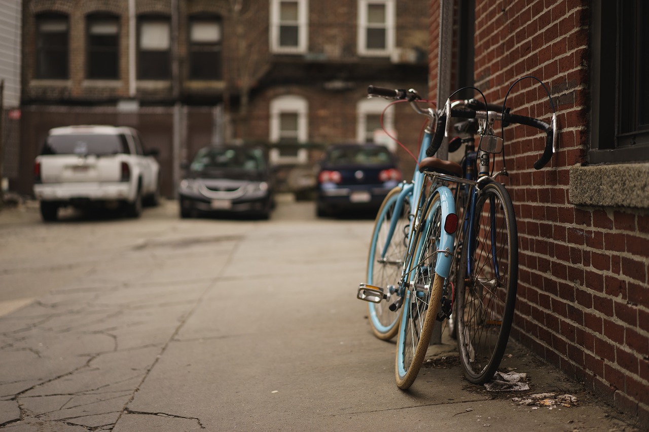 Image - alley bicycles brick wall cars