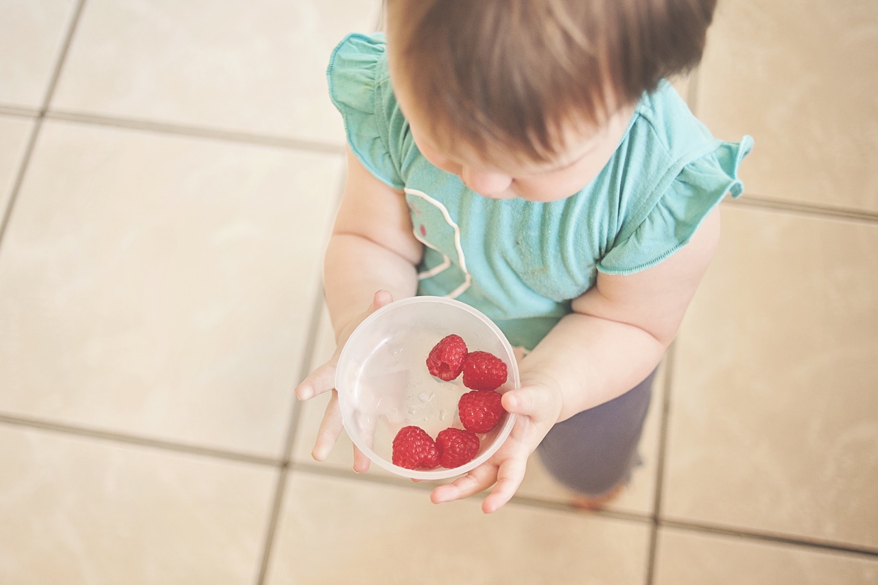 Image - toddler raspberries holding food