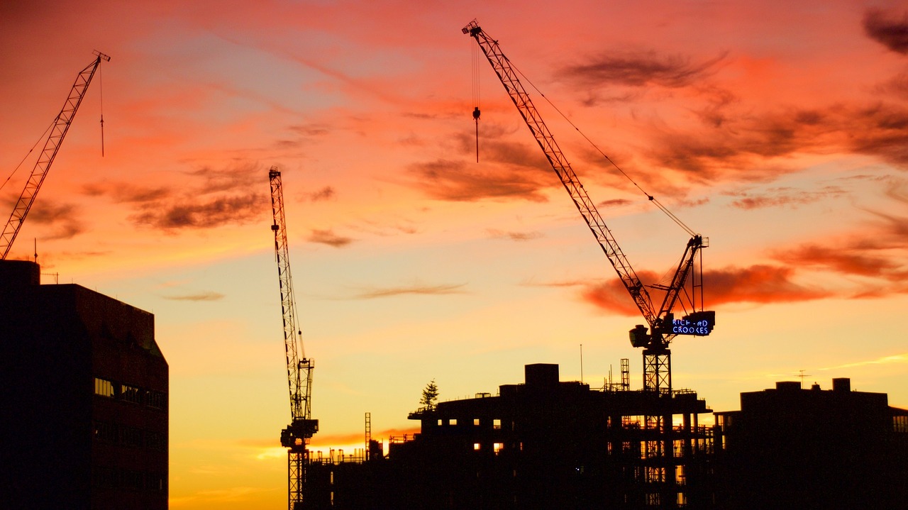 Image - sunrise construction cranes sky