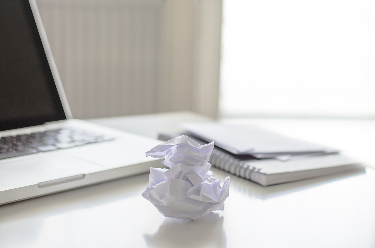 Image - busy home desk paper laptop view