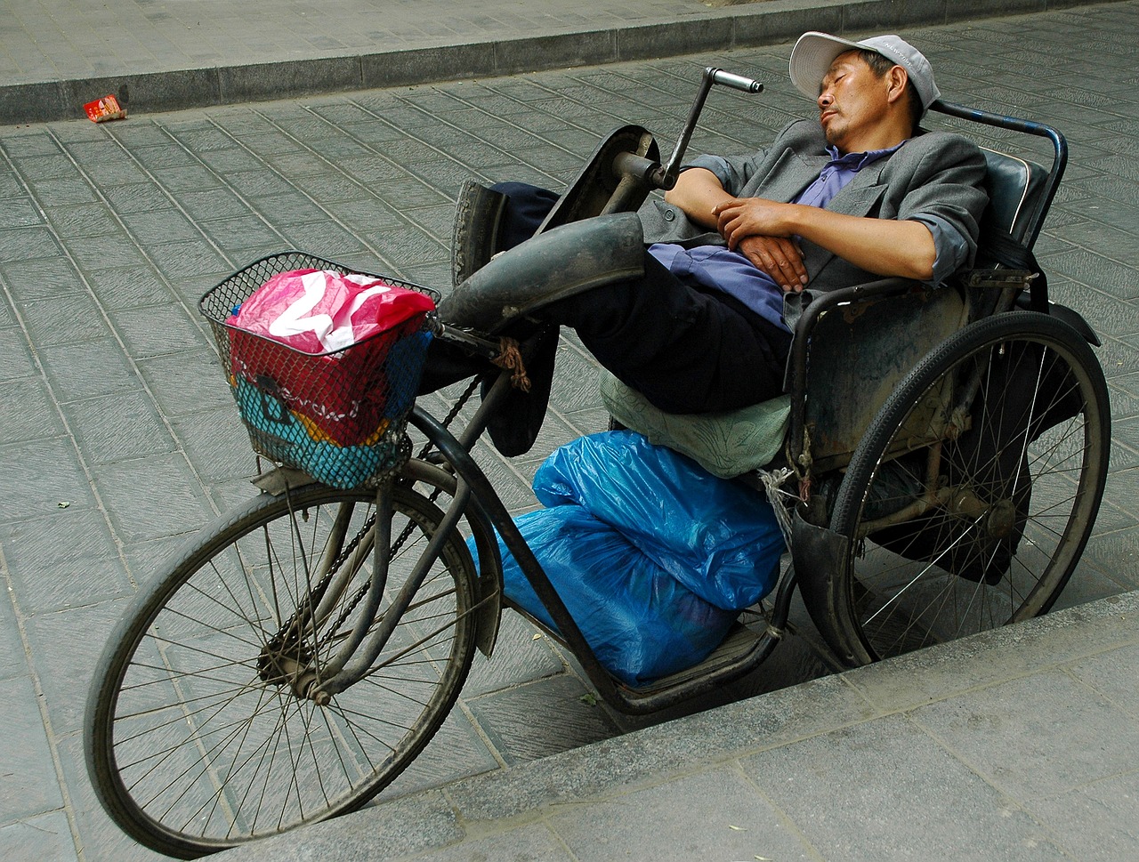 Image - man sleep china bike street