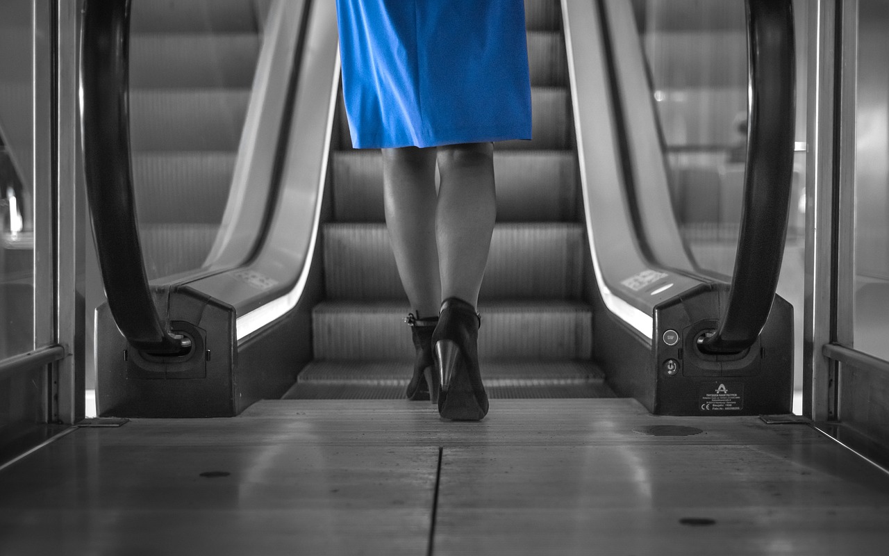 Image - woman blue dress escalator dress