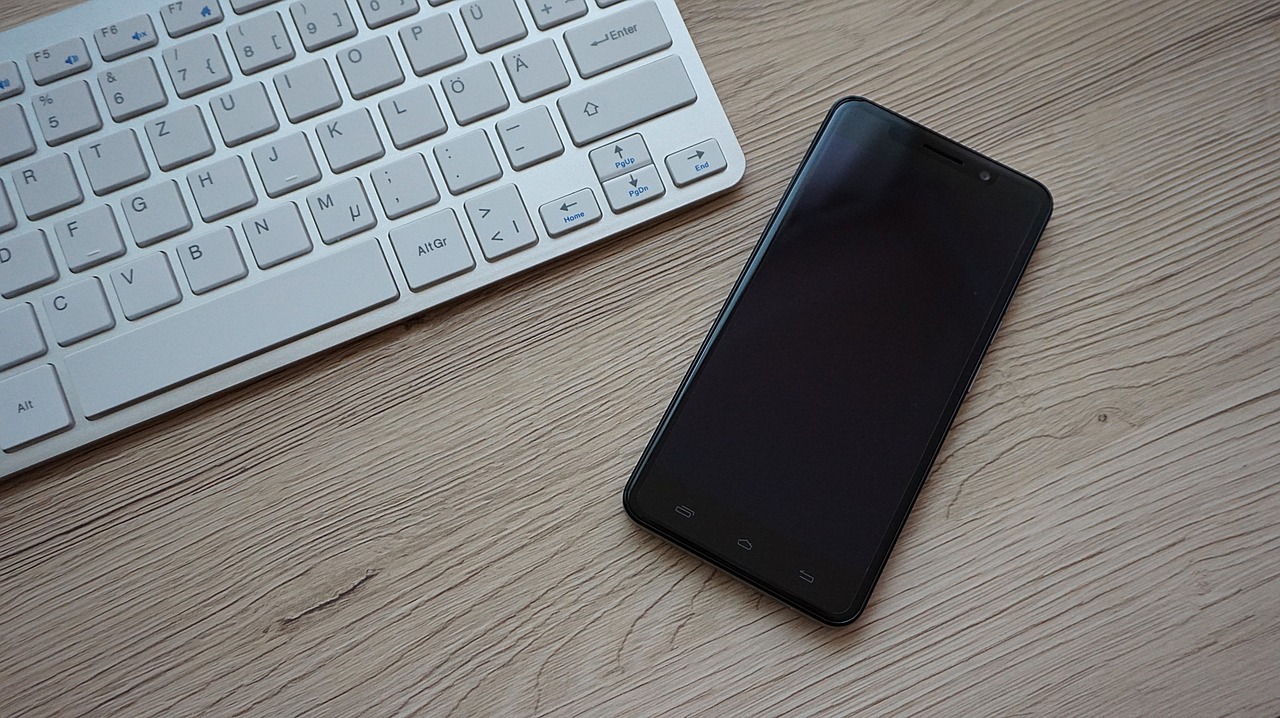 Image - smartphone keyboard desk workplace