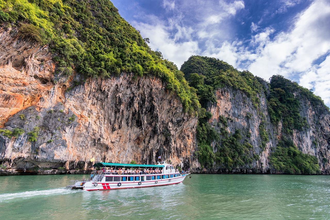 Image - cliff ocean boat tourists green