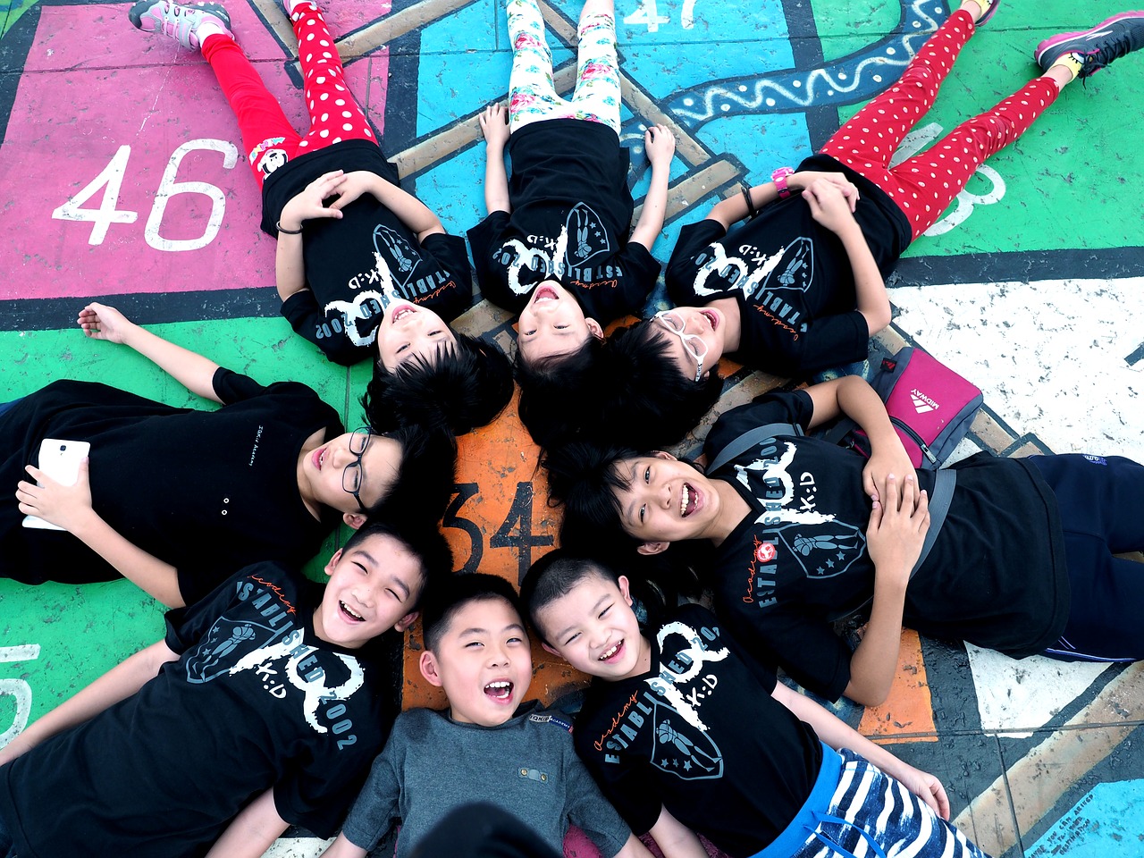 Image - children lying down in circle boys