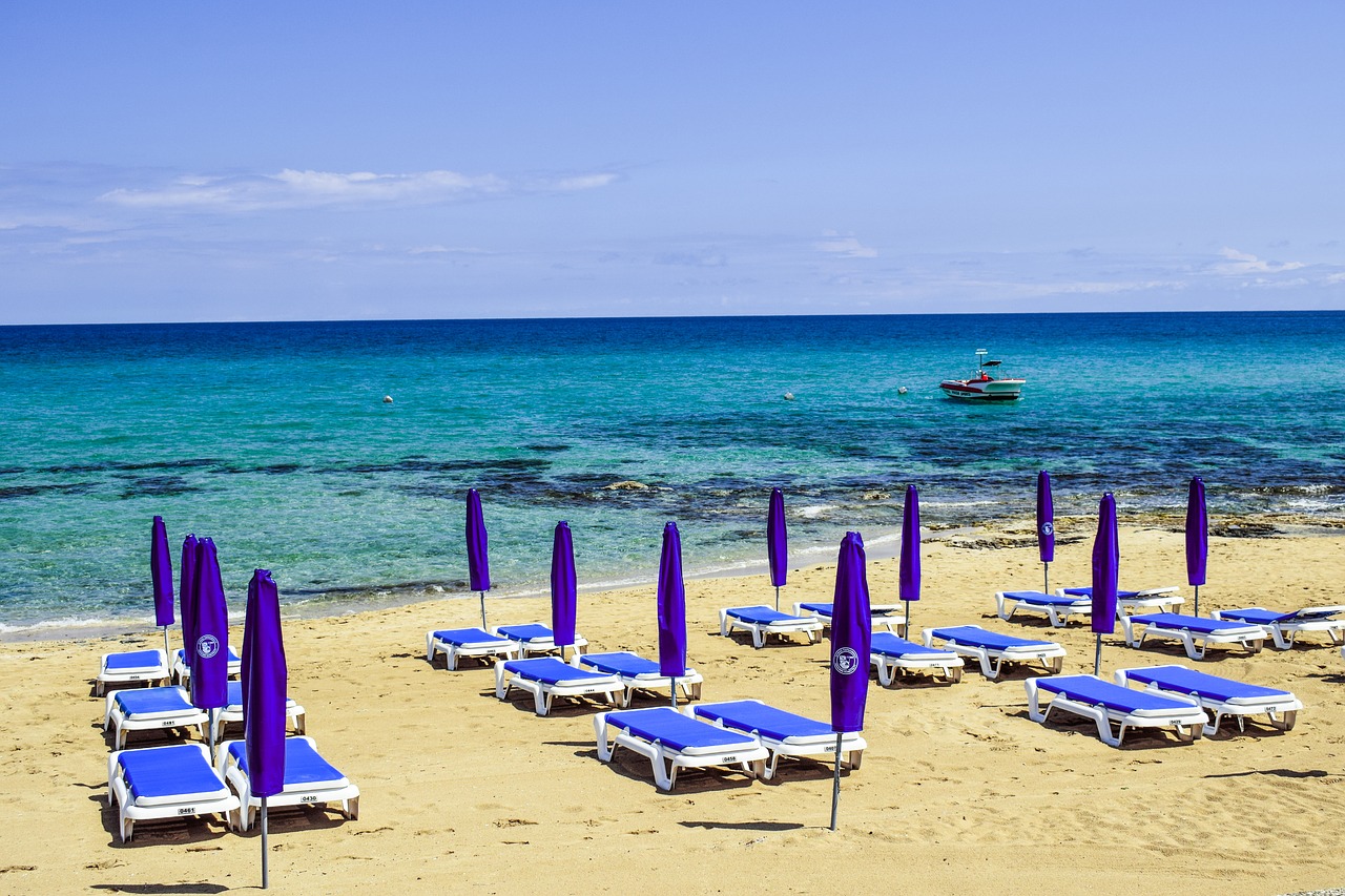 Image - beach sand sea sunbed umbrella