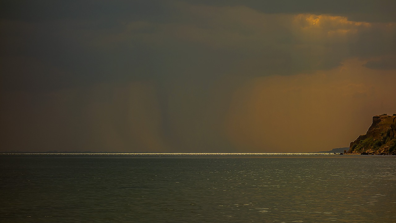 Image - rock sea clouds rays
