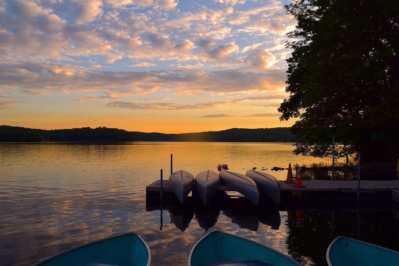 Image - canoes sunset lake tree water