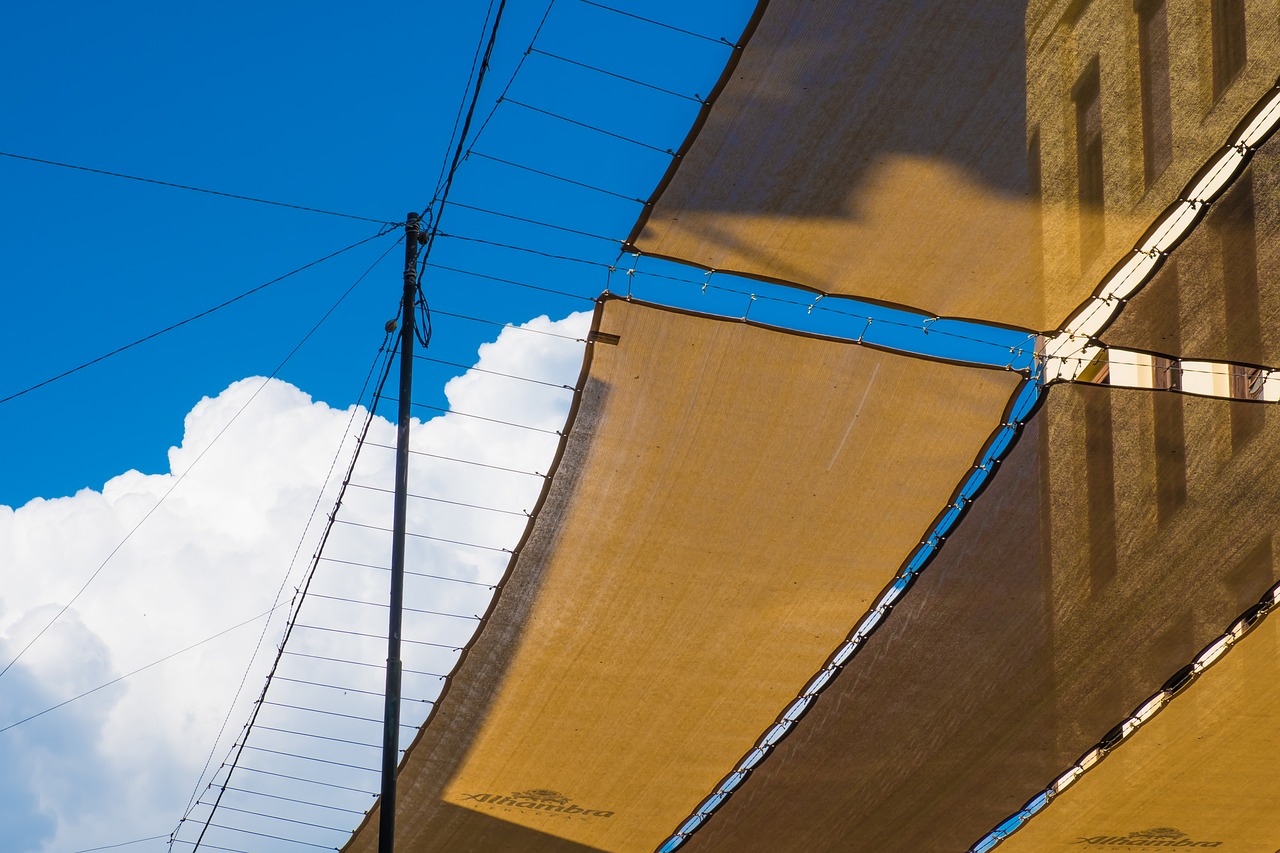Image - sky clouds awnings shadow street
