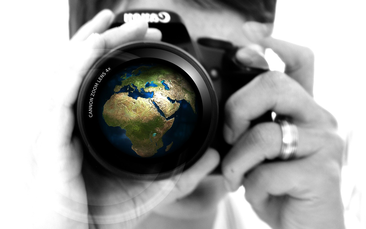 Image - woman camera hand lens earth
