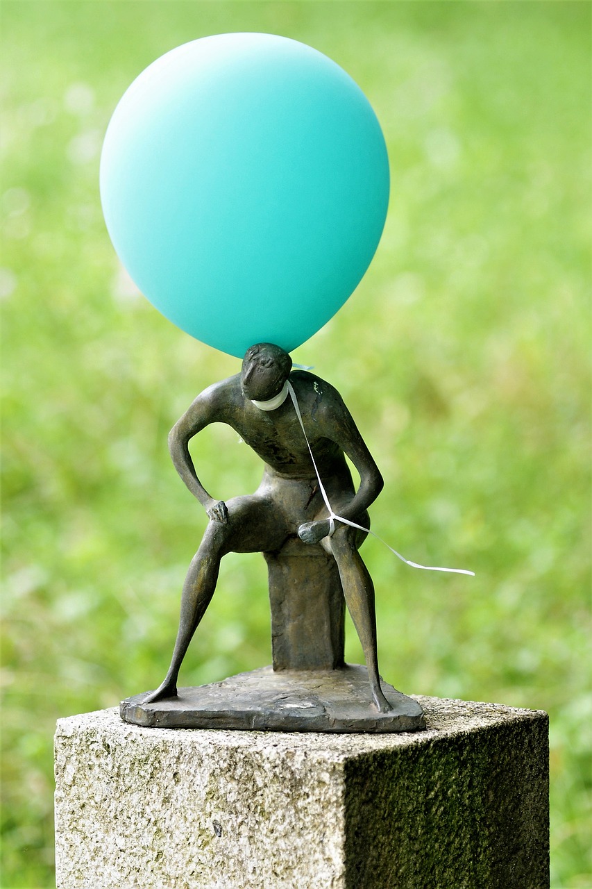 Image - sculpture man sitting one balloon