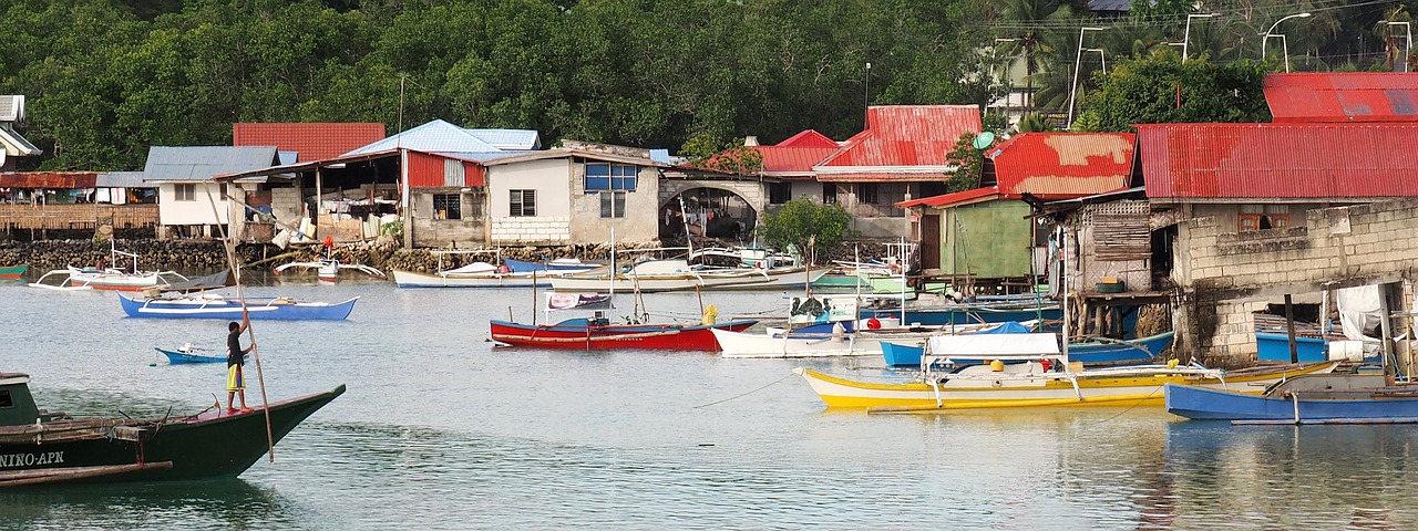 Image - boats stilt houses river bank