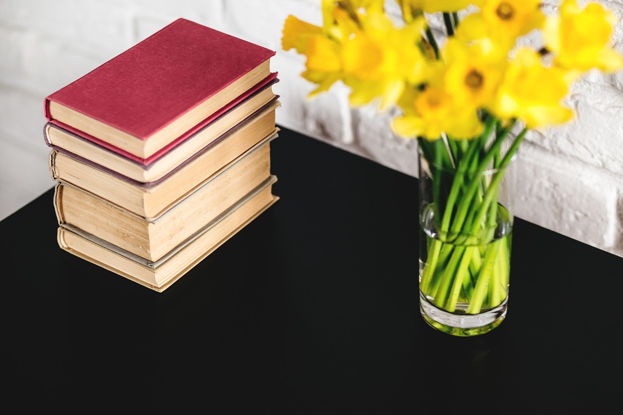 Image - yellow flower vase table books