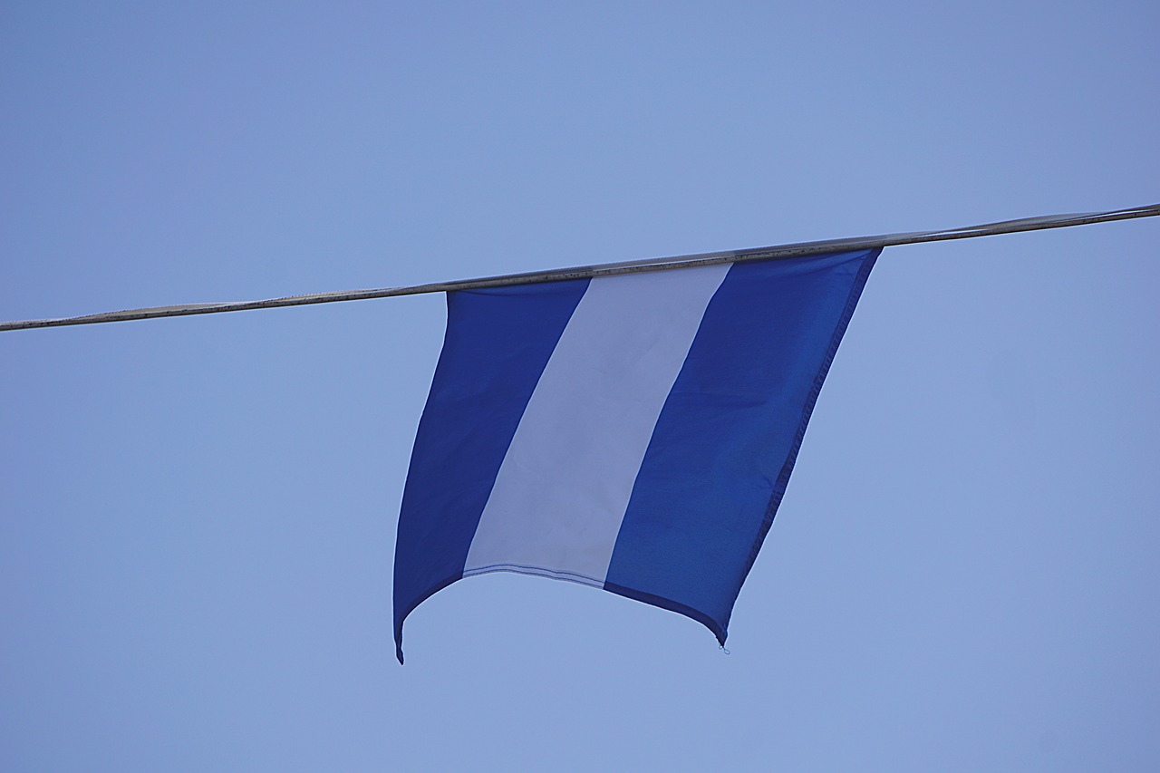 Image - flag blue white cable hung sky