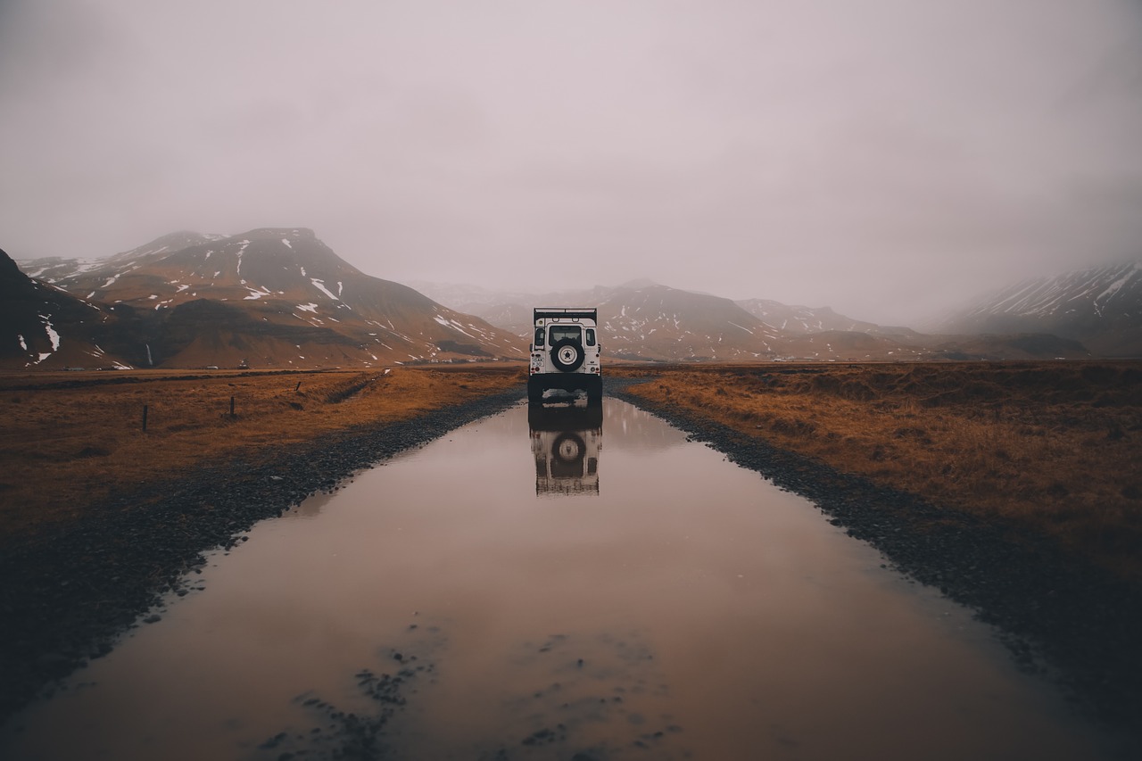 Image - road vehicle mountains reflect