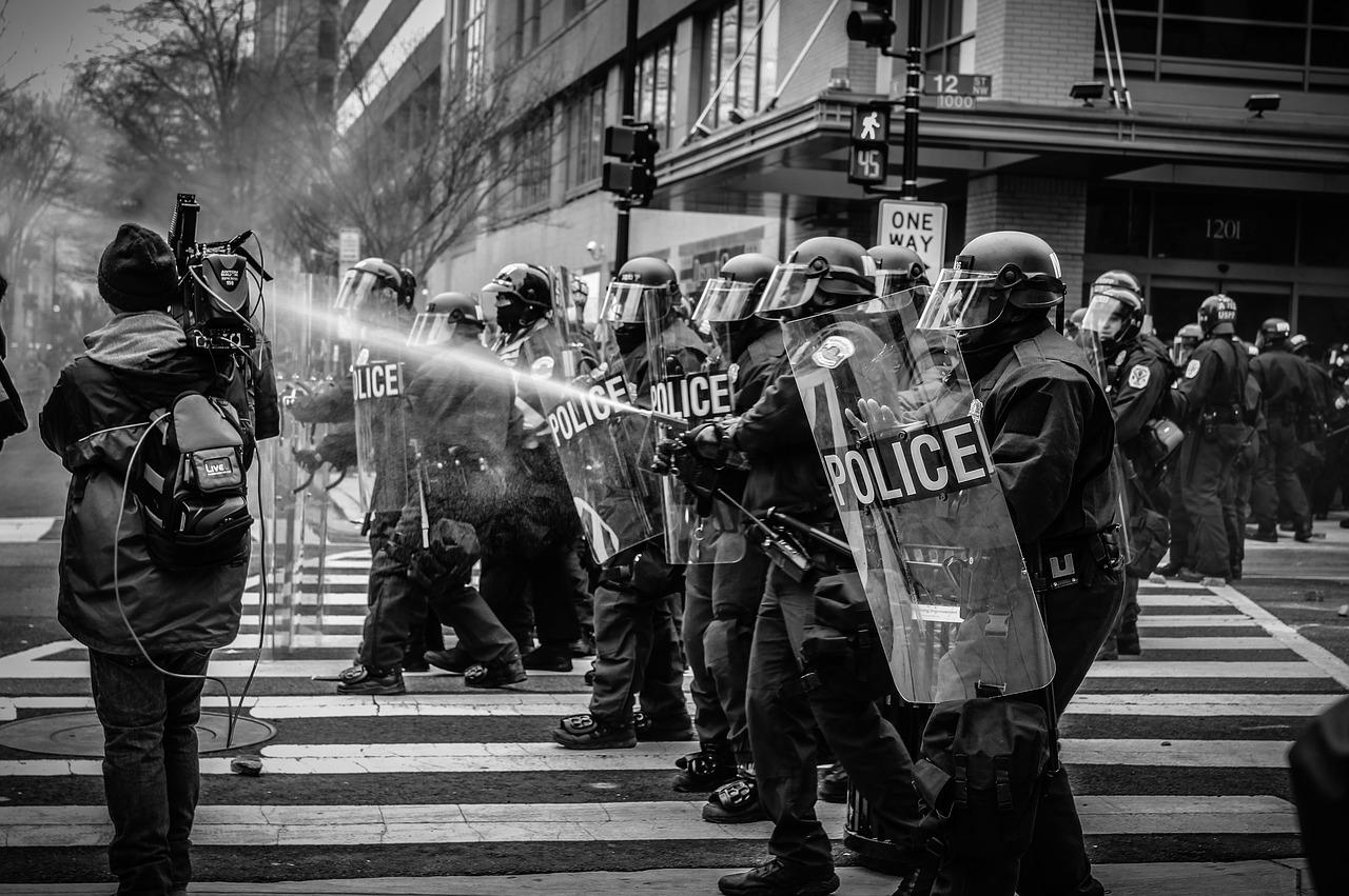 Image - people police protest water shield