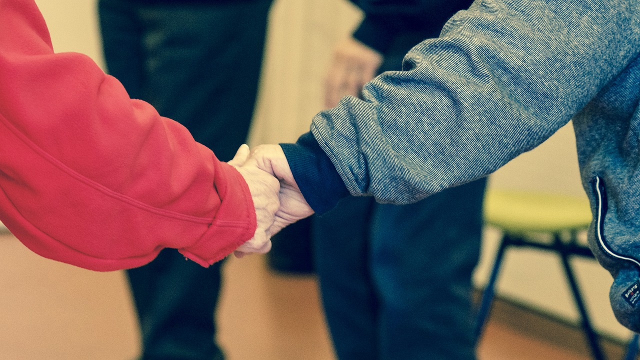 Image - holding hand red blue jacket