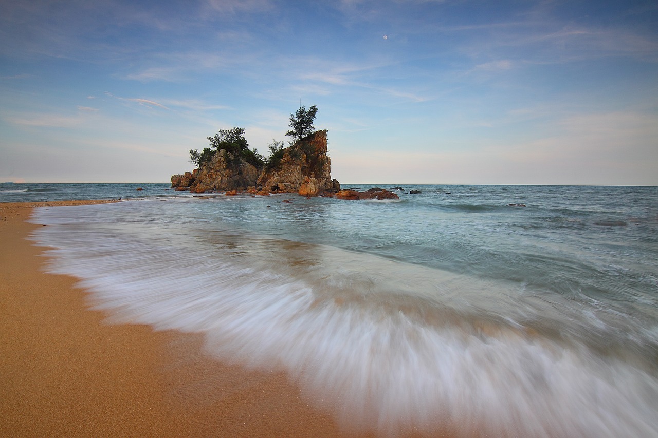 Image - beach sand sea water hill rock