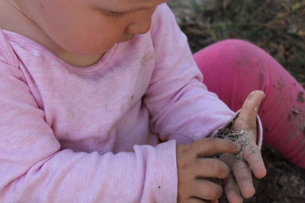 Image - child hand stones gravel hands