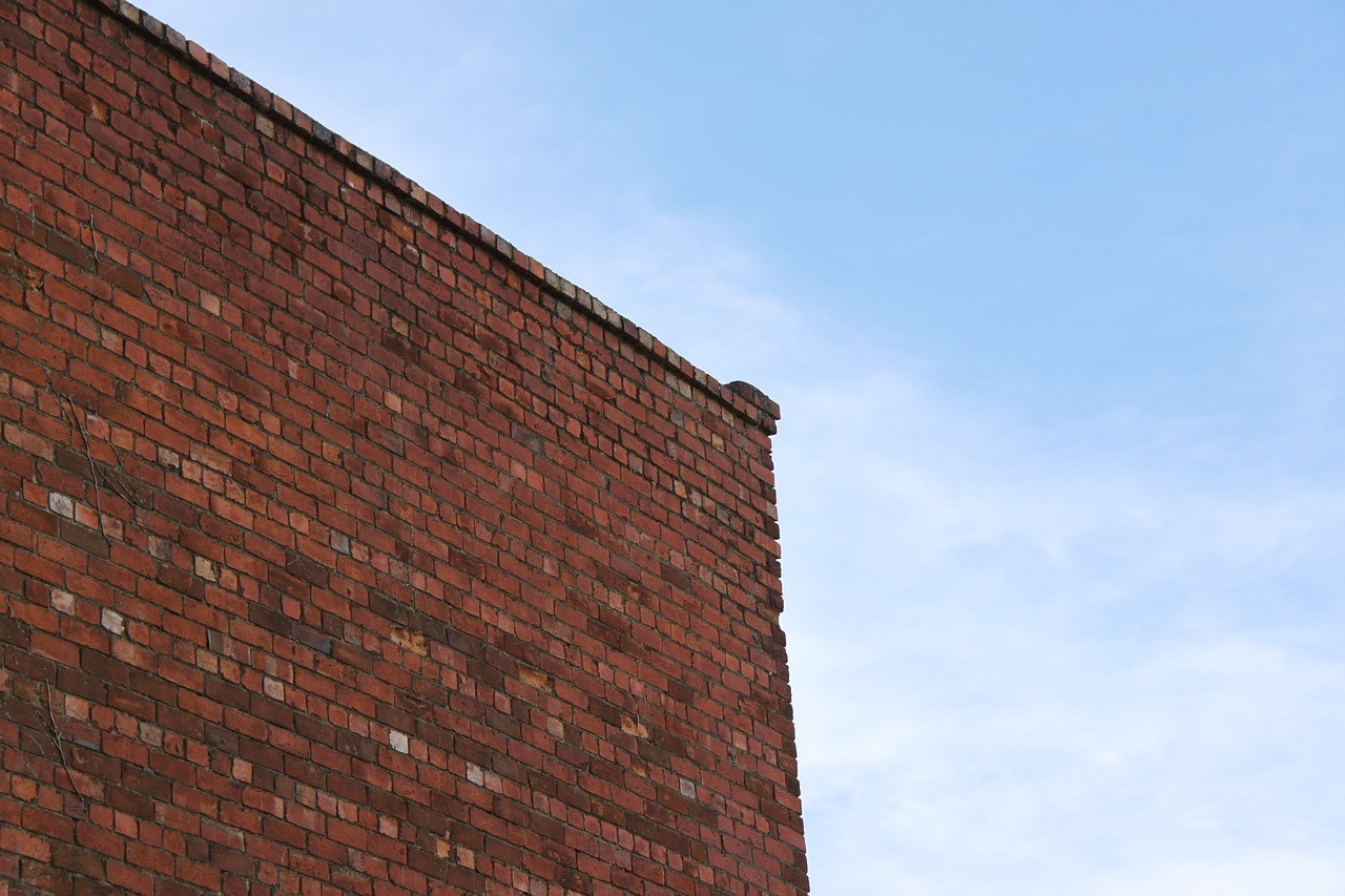 Image - brick building wall sky blue red