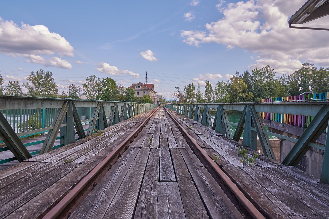 Image - tracks clouds bridge sky building