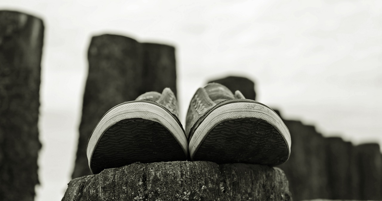 Image - sneakers shoes pair bollard beach