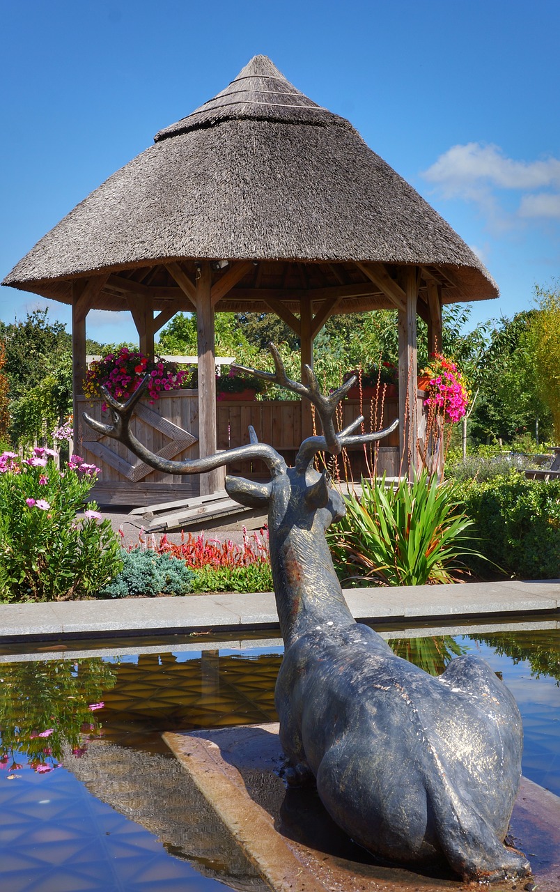 Image - bronze deer thatched seating area