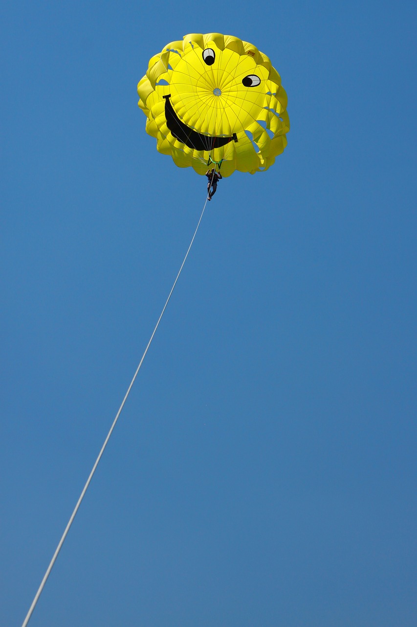 Image - parachute yellow blue landscape