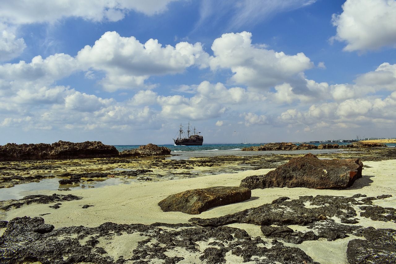 Image - rocky coast sea sky clouds boat