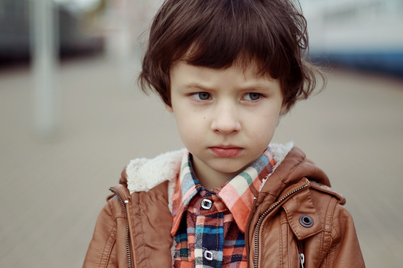 Image - portrait of a boy boy frowning