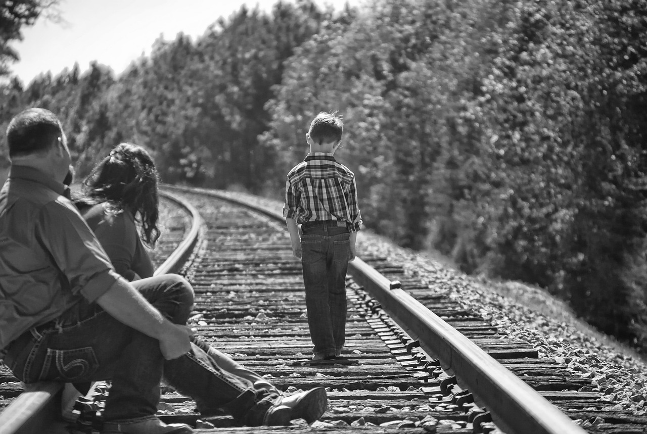 Image - boy parents walking railroad tracks