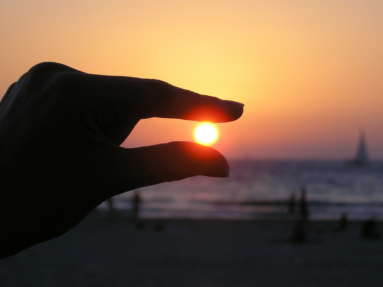 Image - sun in the hand fingers sunset