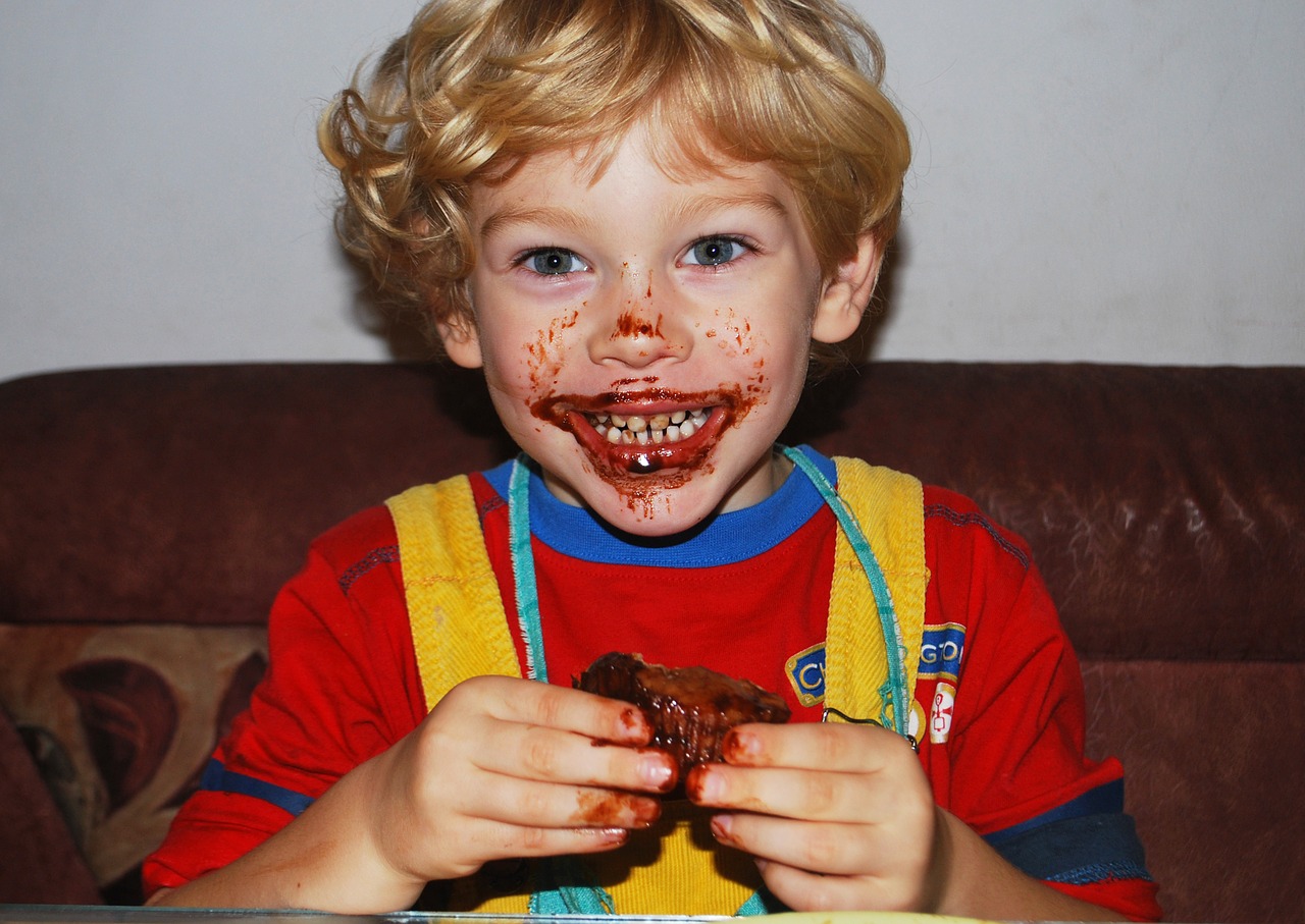 Image - boy eating chocolate muffin