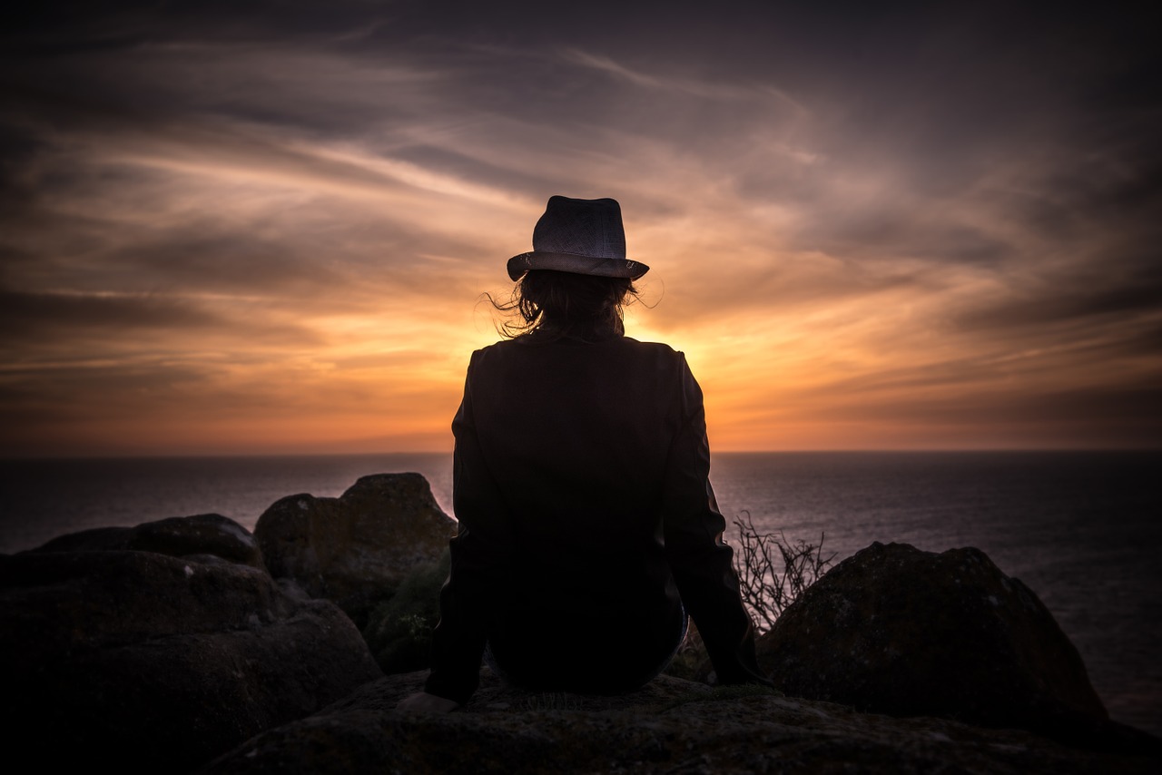 Image - person sitting seaside sunset