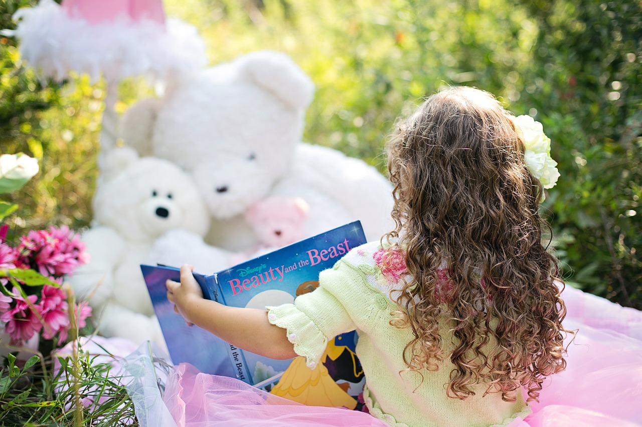 Image - little girl reading garden child