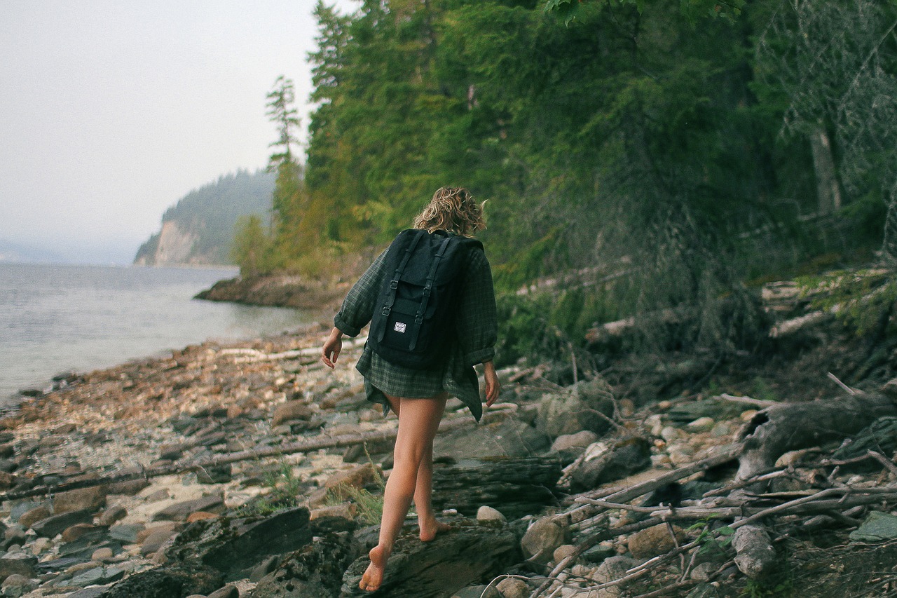 Image - woman hiking trees woods knapsack