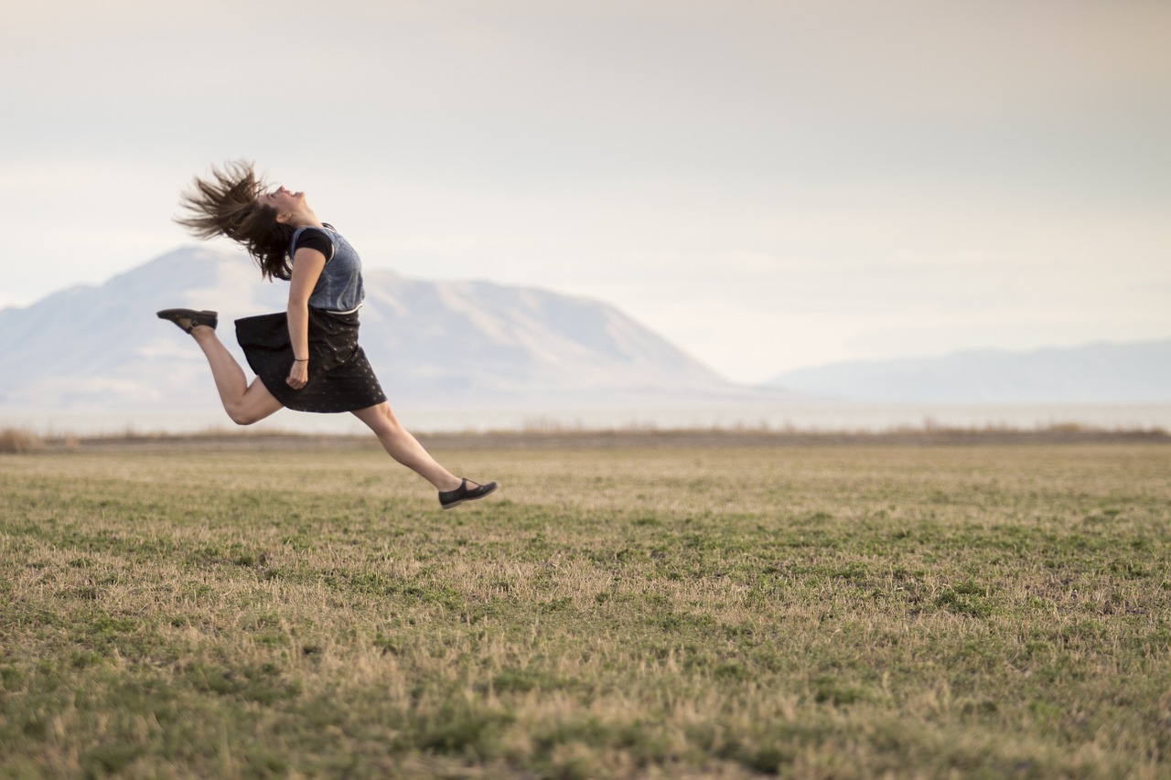 Image - girl jumping happy smiling field