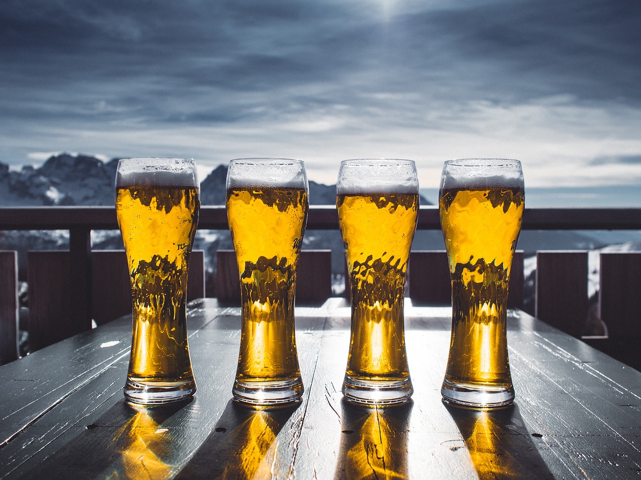 Image - beer glass table sky mountains